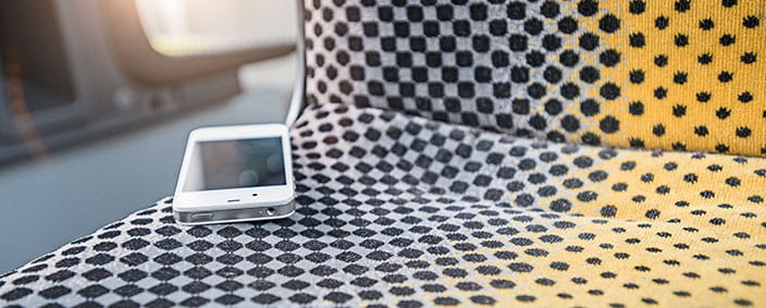 Photo of a smartphone left behind on the seat of a bus