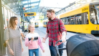 Familie an Haltestelle